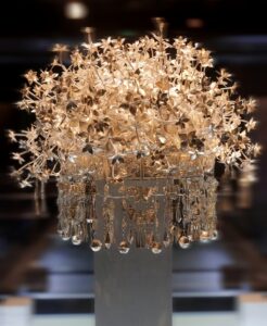 A magnificent traditional silver headpiece with metallic flowers and dangling ornamental bells.