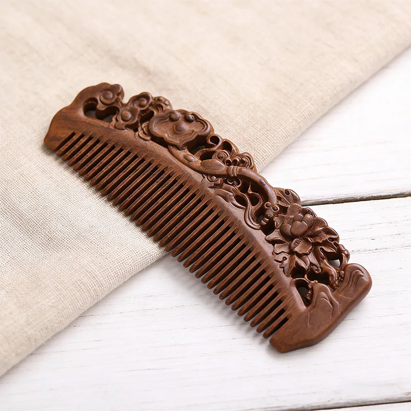 Hand-carved ebony sandalwood comb in close detail