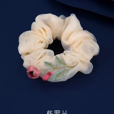 Artisan Camellia Silk Scrunchie Quiet Bloom in 100% mulberry silk with hand-stitched floral motif