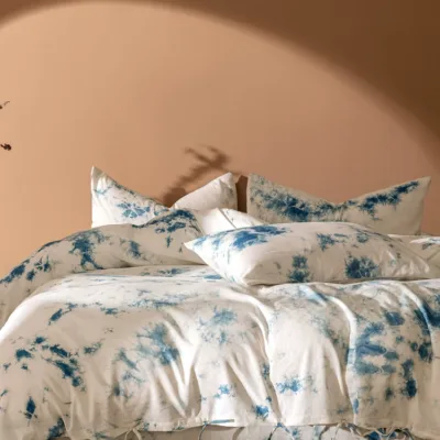 Handmade indigo plant cloud dyeing cotton and linen four-piece set lifestyle display on natural backdrop