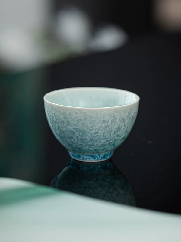 Blue crystalline glaze teacup with softly radiating glaze marks