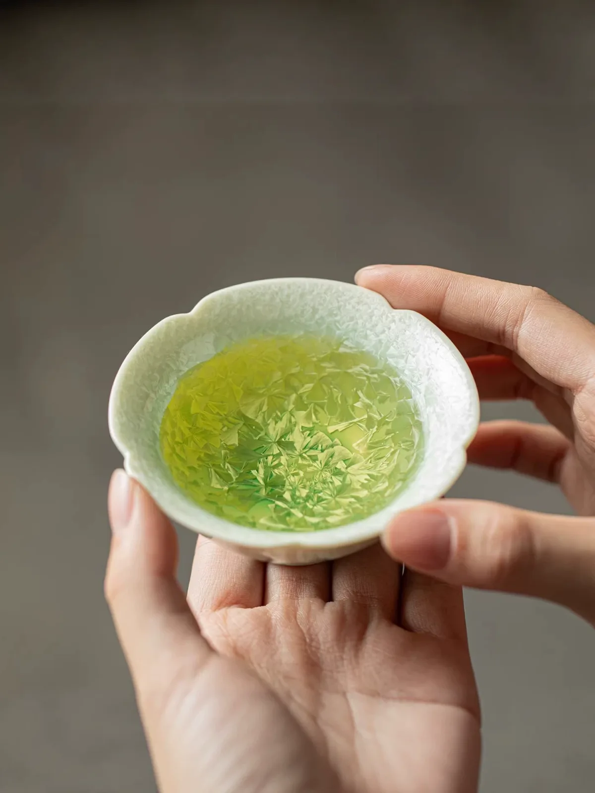 Gradient green crystalline glaze teacup in close detail