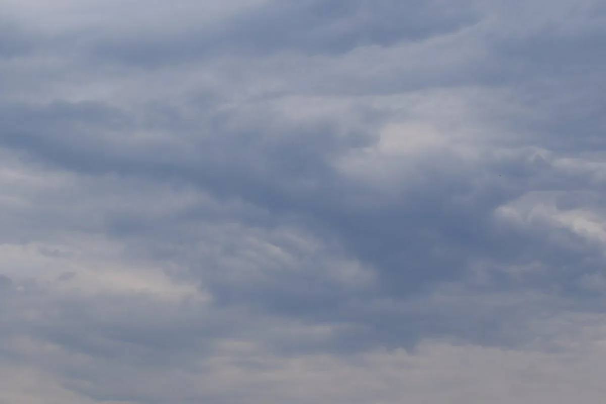 Silver earrings on a neutral surface — minimal and precise