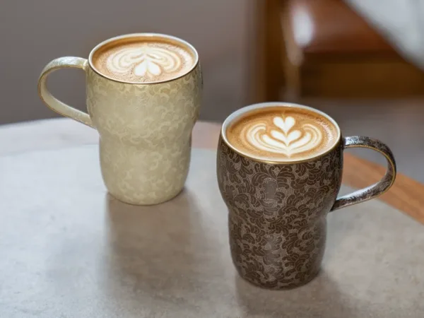 Carved Ceramic Coffee Mug showing carved relief ceramic surface texture